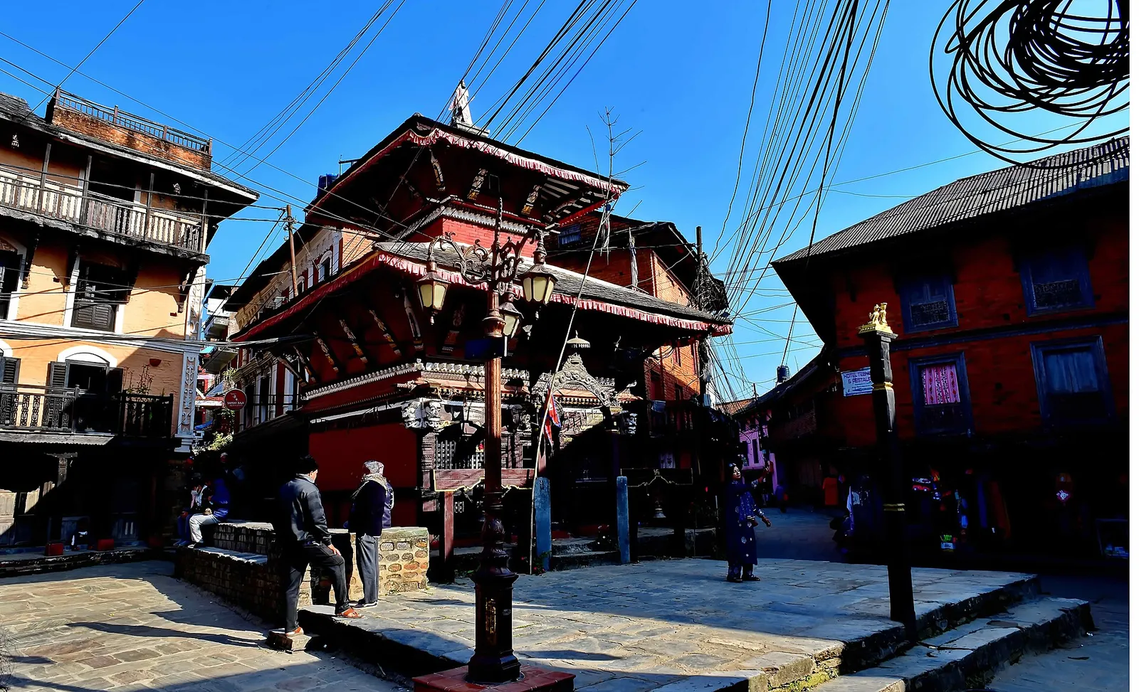 The red-brick, two-tiered Bindabasini temple on Bandipur's stone-paved bazaar square, with old Newar houses around it