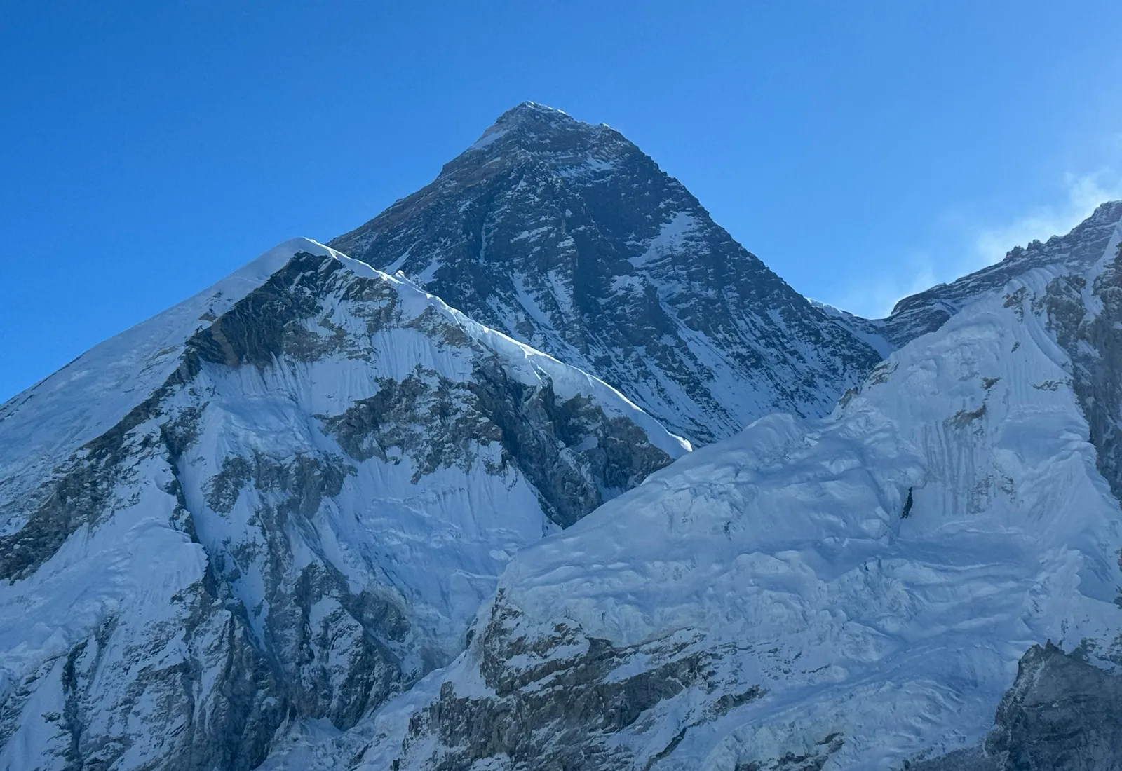 The summit pyramid of Everest under a clear blue sky