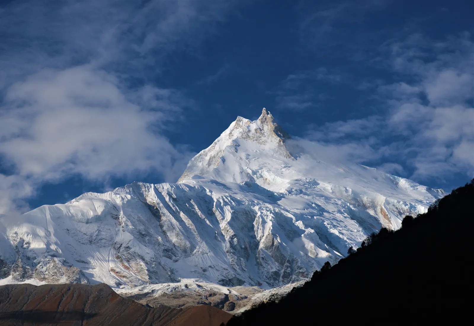 Snow-covered Manaslu under a clear blue sky