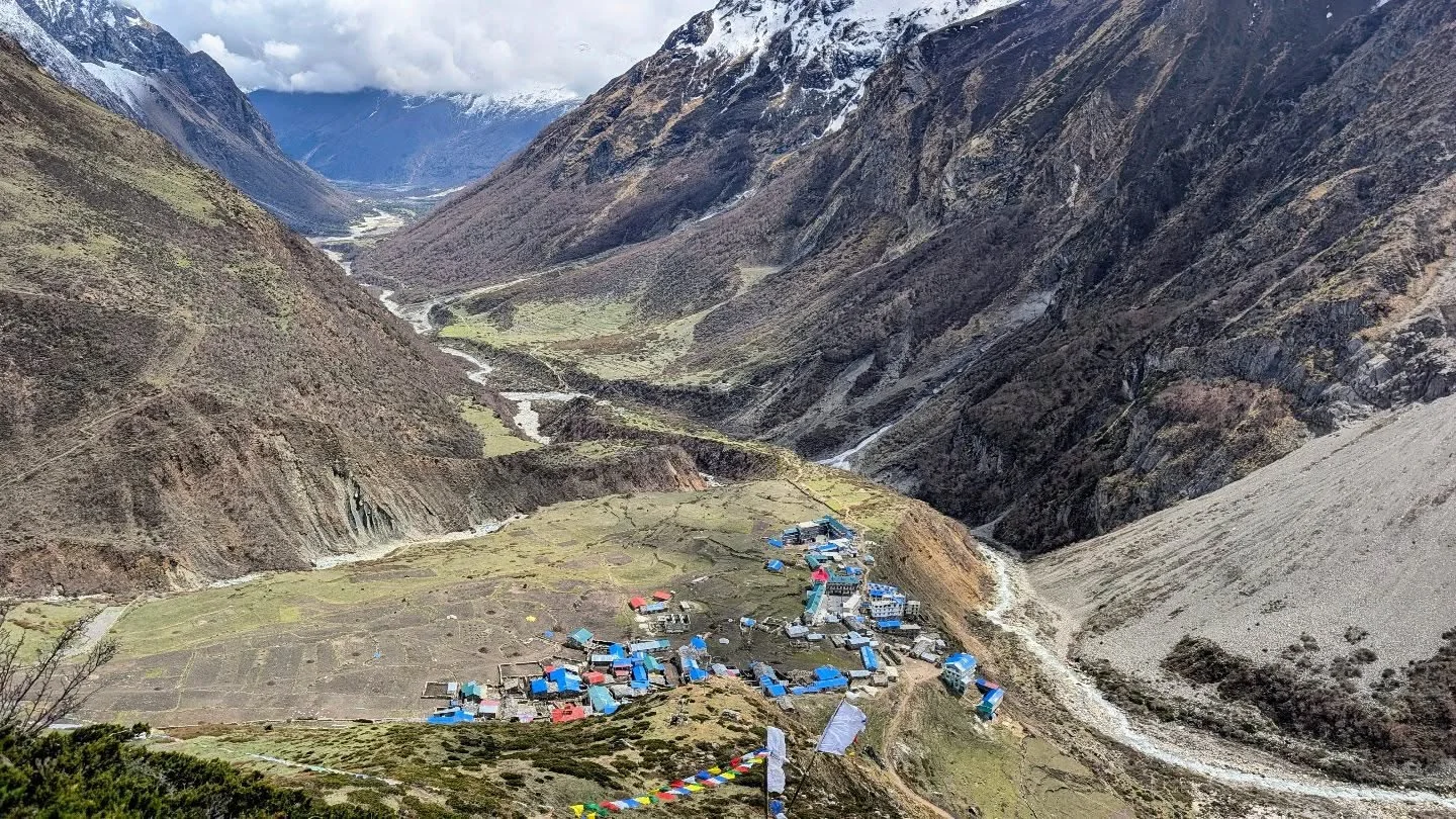 The village of Samdo at 3,875m seen from above, prayer flags in the foreground and the Buri Gandaki valley below