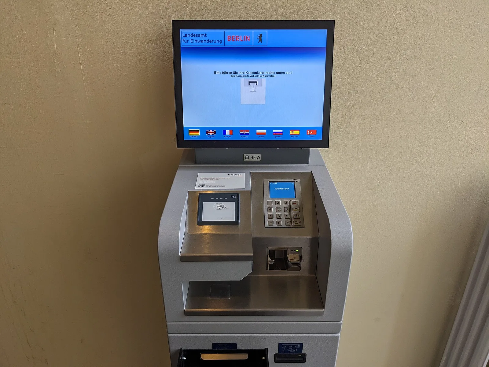 A card payment terminal ready to take a contactless payment — a reminder to always pay in the local currency to avoid dynamic currency conversion fees