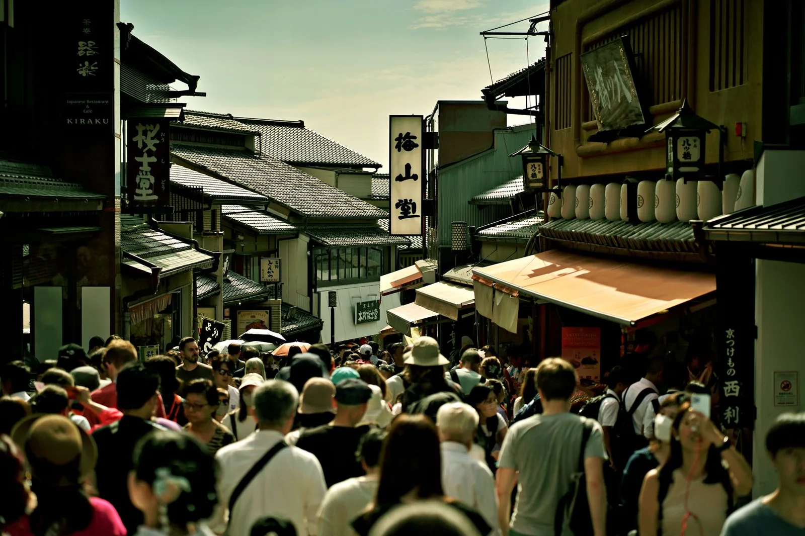 A busy, crowded shopping street packed with people — the kind of tightly packed public place where pickpockets and bag-snatchers work