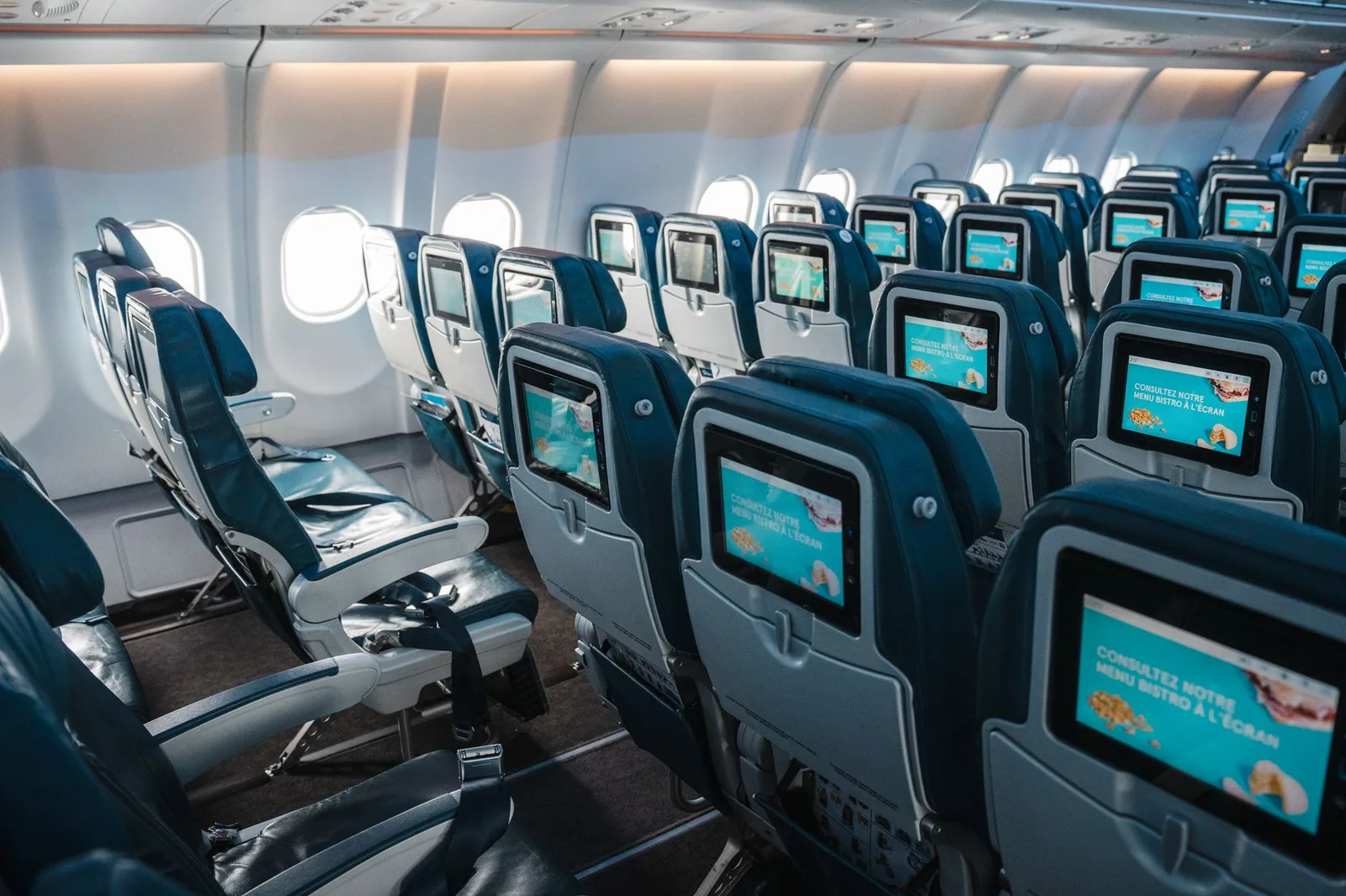 Rows of economy-class seats inside a passenger aircraft cabin