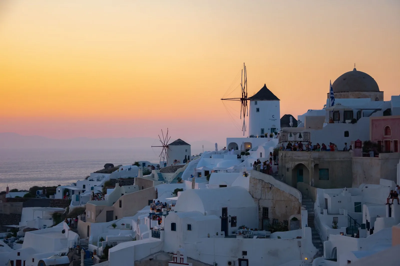 The whitewashed cliff village of Oia on Santorini, Greece — a classic shoulder-season travel destination