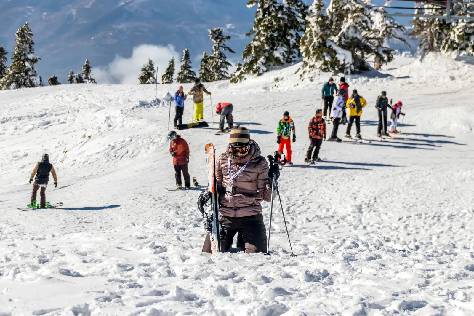 Skiers on a snow-covered mountain slope at a ski resort — Eastern Europe and the Pyrenees offer Alpine-style skiing at a fraction of marquee-resort prices