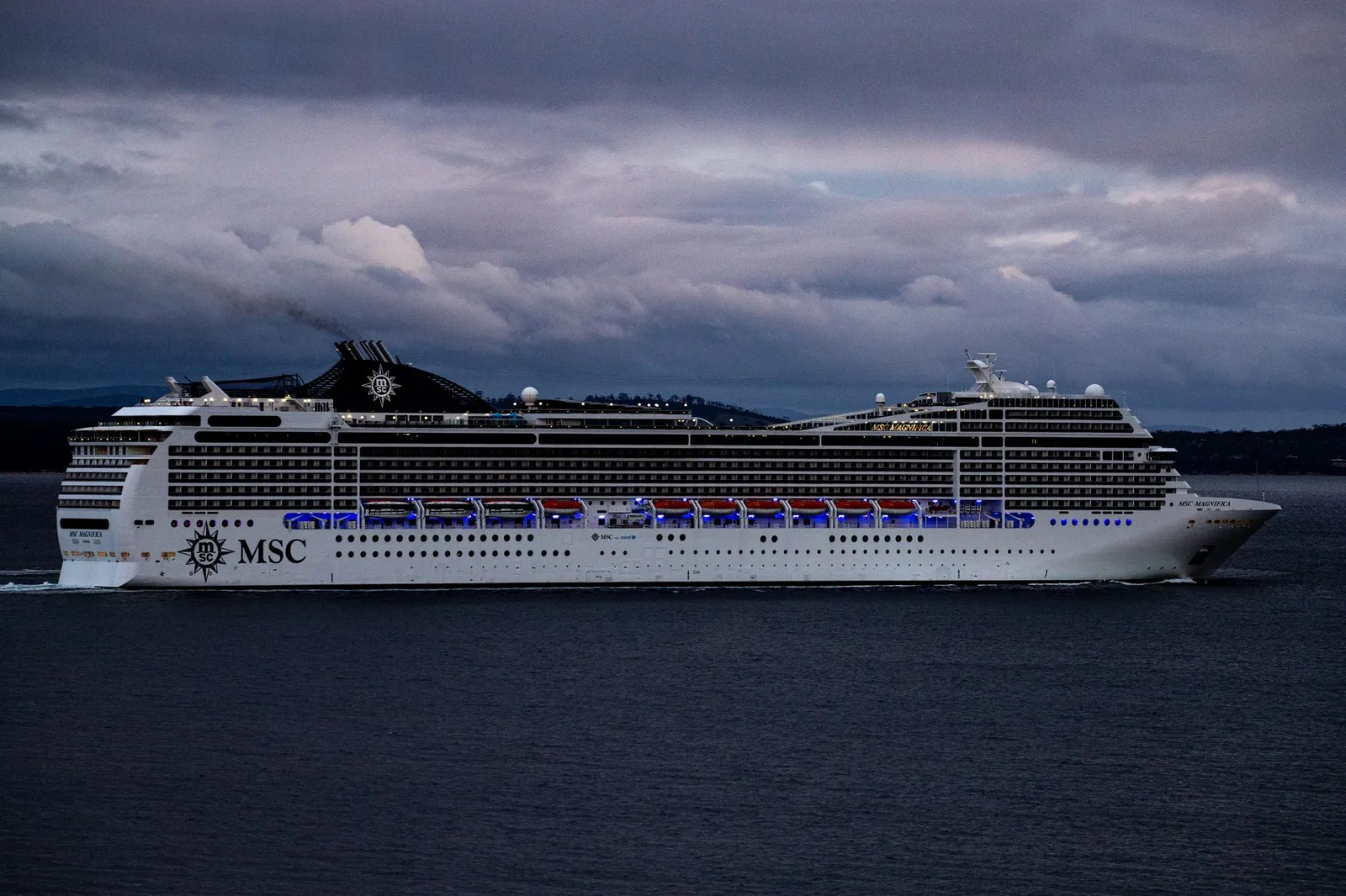 A large cruise ship sailing on the open ocean at sea — where onboard medical care is limited and reaching a hospital can mean an at-sea evacuation