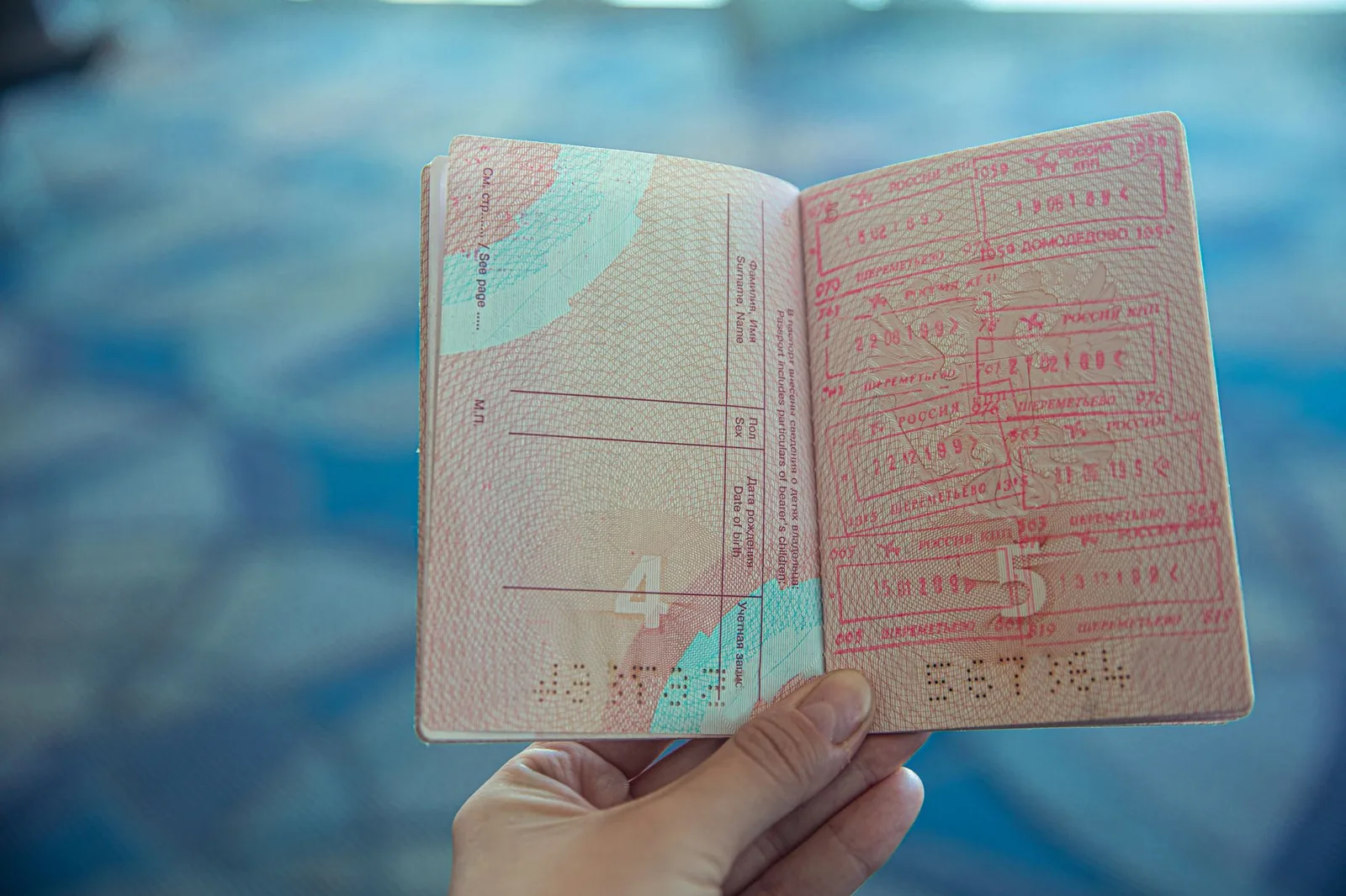 A passport open on stamped visa pages beside travel documents - illustrating easy visa-free, visa-on-arrival and eVisa entry.