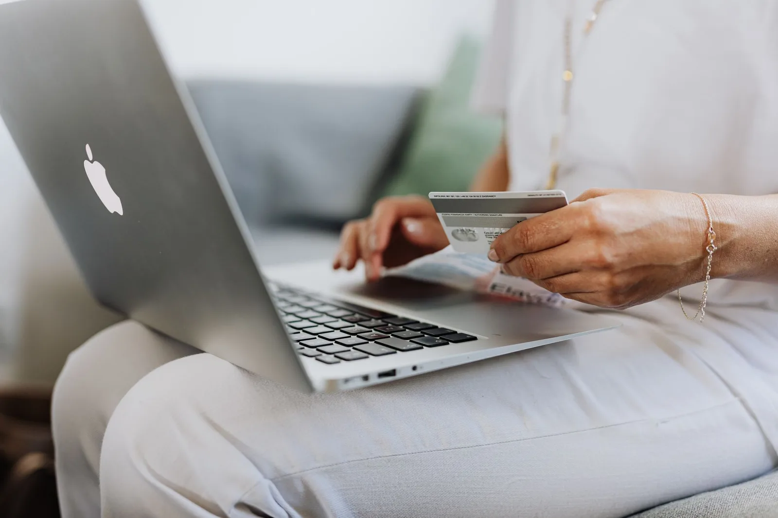 A traveller booking a flight on a laptop with a credit card in hand — how deal hunters pounce when an airline accidentally publishes a wildly underpriced error fare