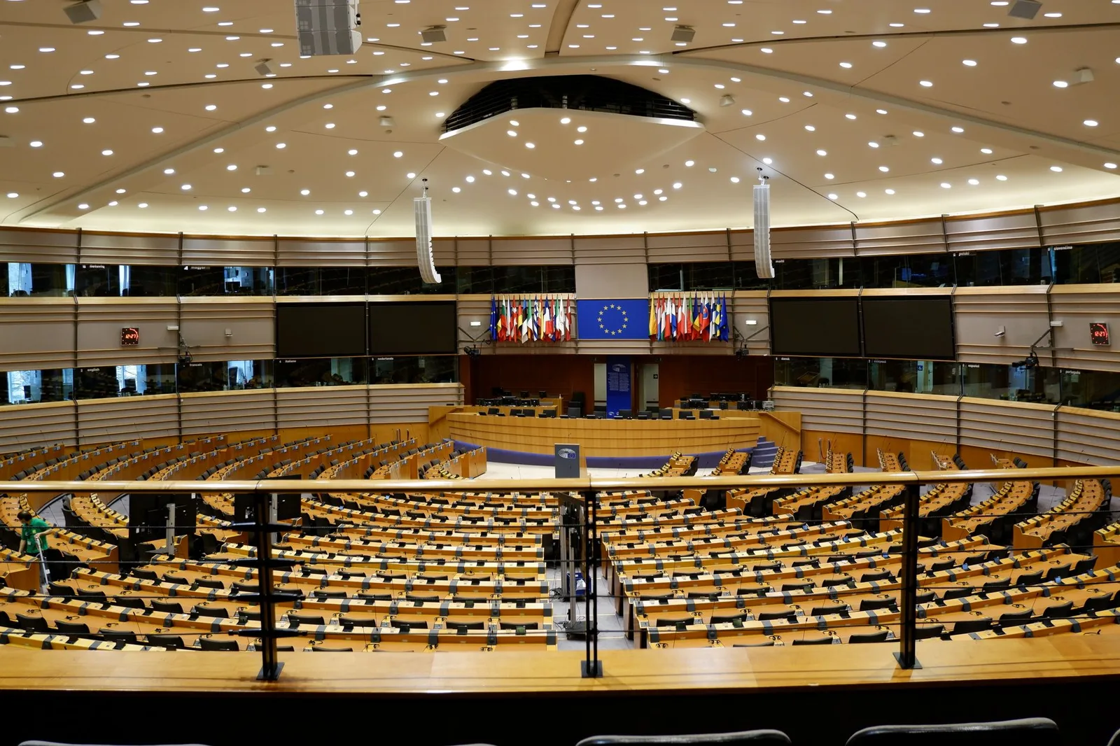 The debating chamber of the European Parliament in Brussels, ringed by EU member-state flags and the European Union emblem — visa-exempt visitors will soon need an ETIAS authorisation to enter the Schengen area
