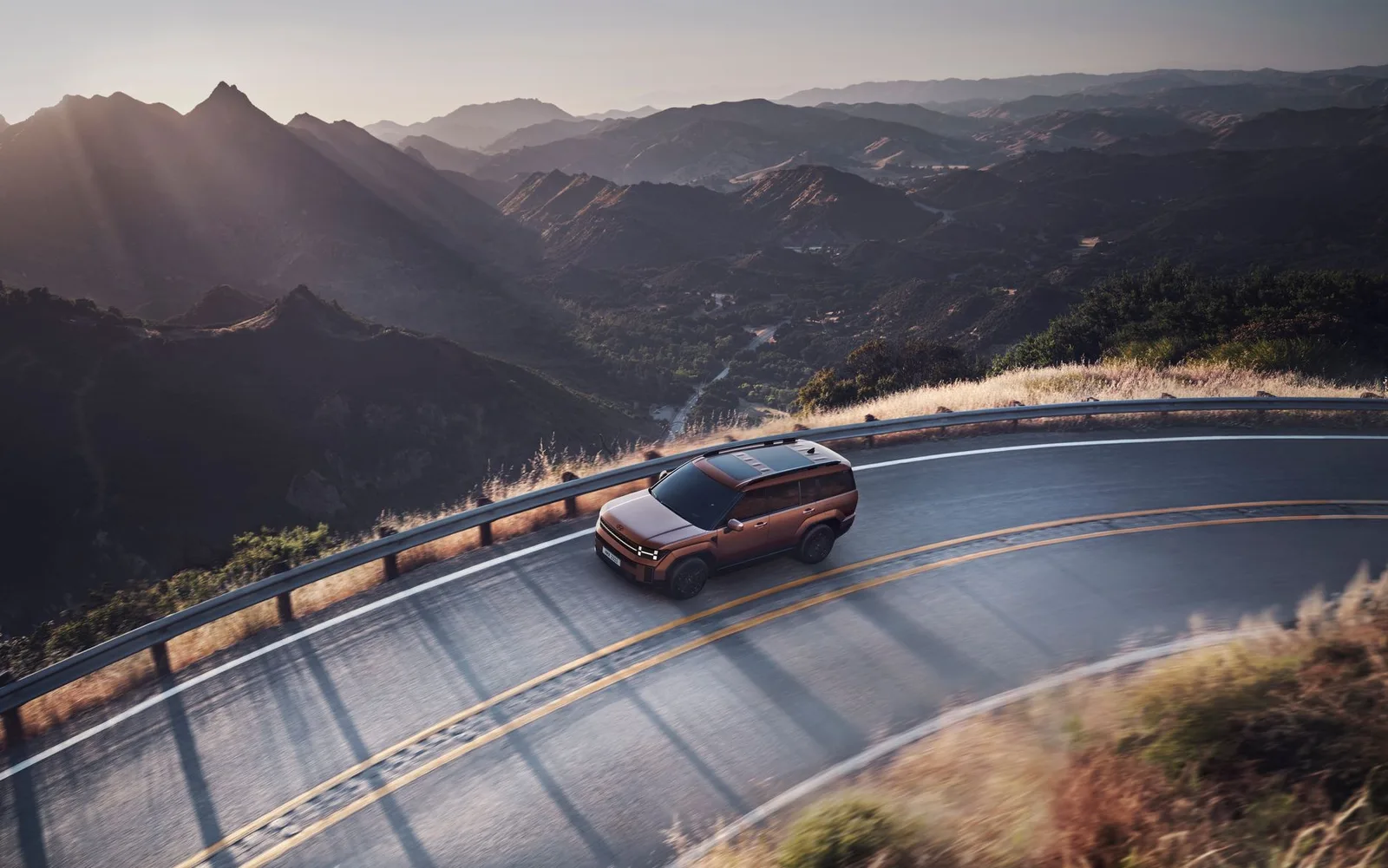A car driving along a winding mountain road, illustrating a self-drive holiday abroad