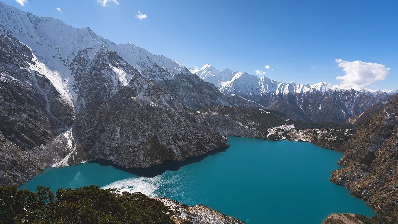 The deep turquoise water of Shey Phoksundo Lake, Nepal’s deepest lake, in Shey Phoksundo National Park, Dolpa district of the far-western Karnali — a trans-Himalayan rain-shadow region hundreds of km from the flood-hit Rasuwa corridor and unaffected by the 2026 floods