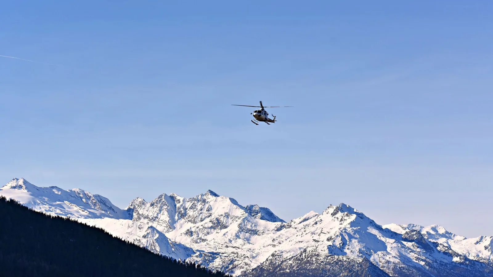 A helicopter flying over the snow peaks of the Nepal Himalaya — the Everest Base Camp helicopter tour is a Kathmandu day-trip by air into the Khumbu (Everest region) in the east, unaffected by the 2026 Rasuwa flood