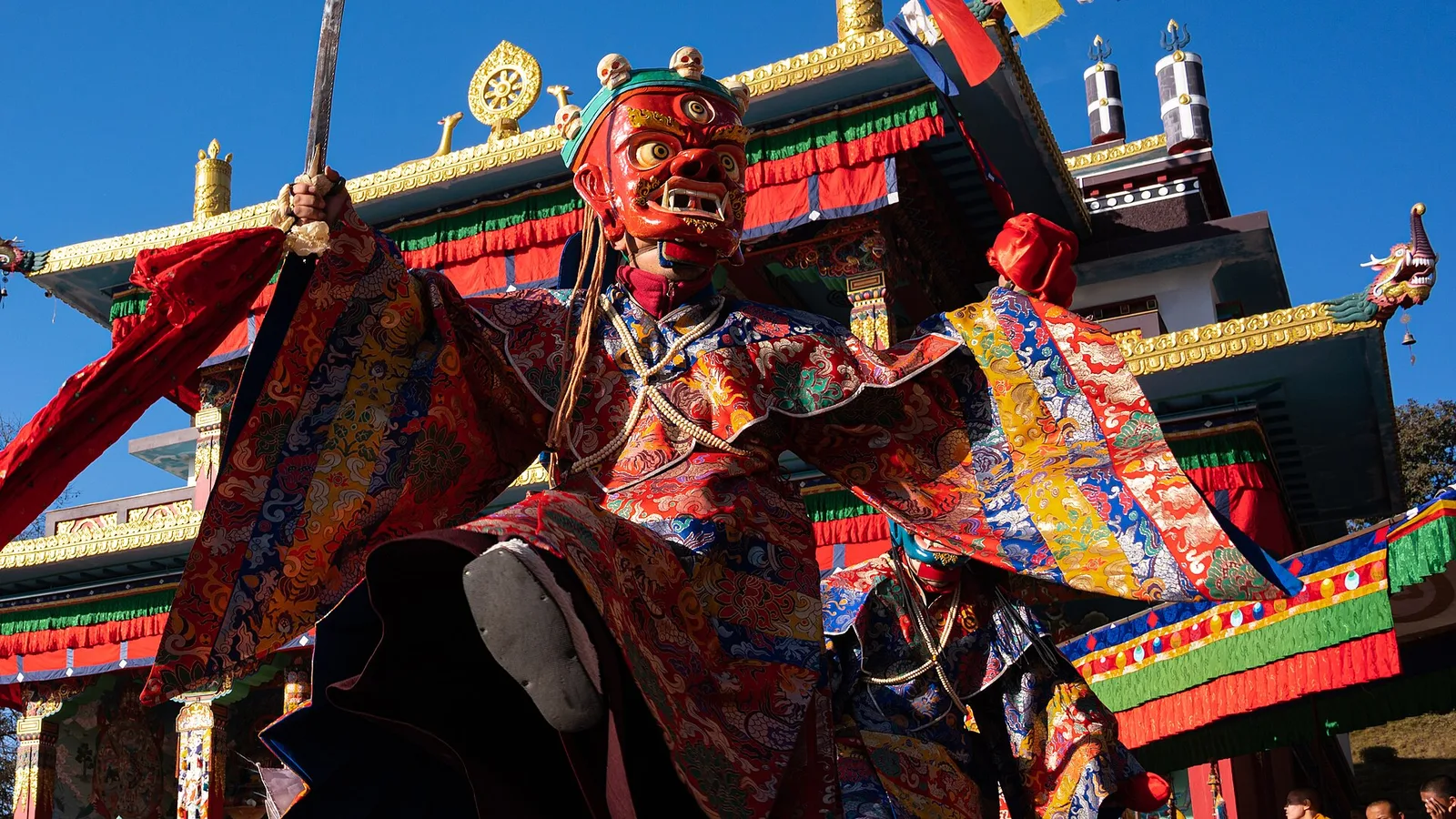 Masked monks performing a cham dance at a Himalayan Buddhist monastery — the ritual masked dance at the heart of Losar and other festivals in Nepal’s high country