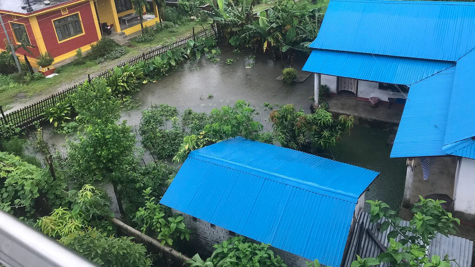 File photo: a swollen, muddy monsoon river tearing through a Himalayan valley in Nepal — an illustrative context image of monsoon flooding, not the 26–27 August 2026 floods