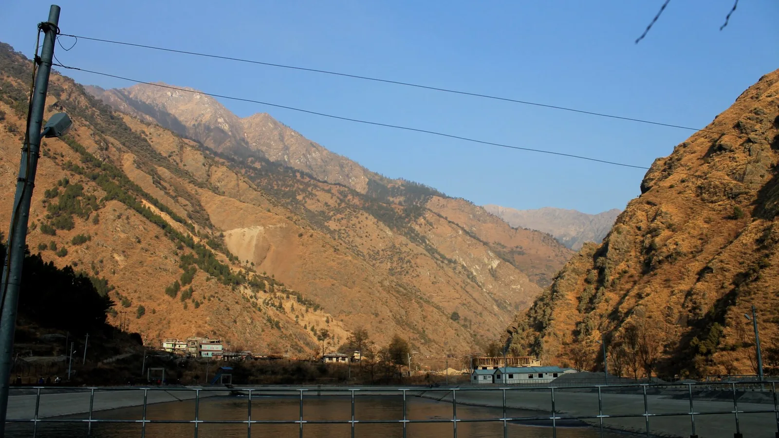 File photo: a hydropower dam and powerhouse on a fast, glacier-fed Himalayan river in Nepal — a context image of run-of-river hydropower, not the 26 August 2026 flood damage