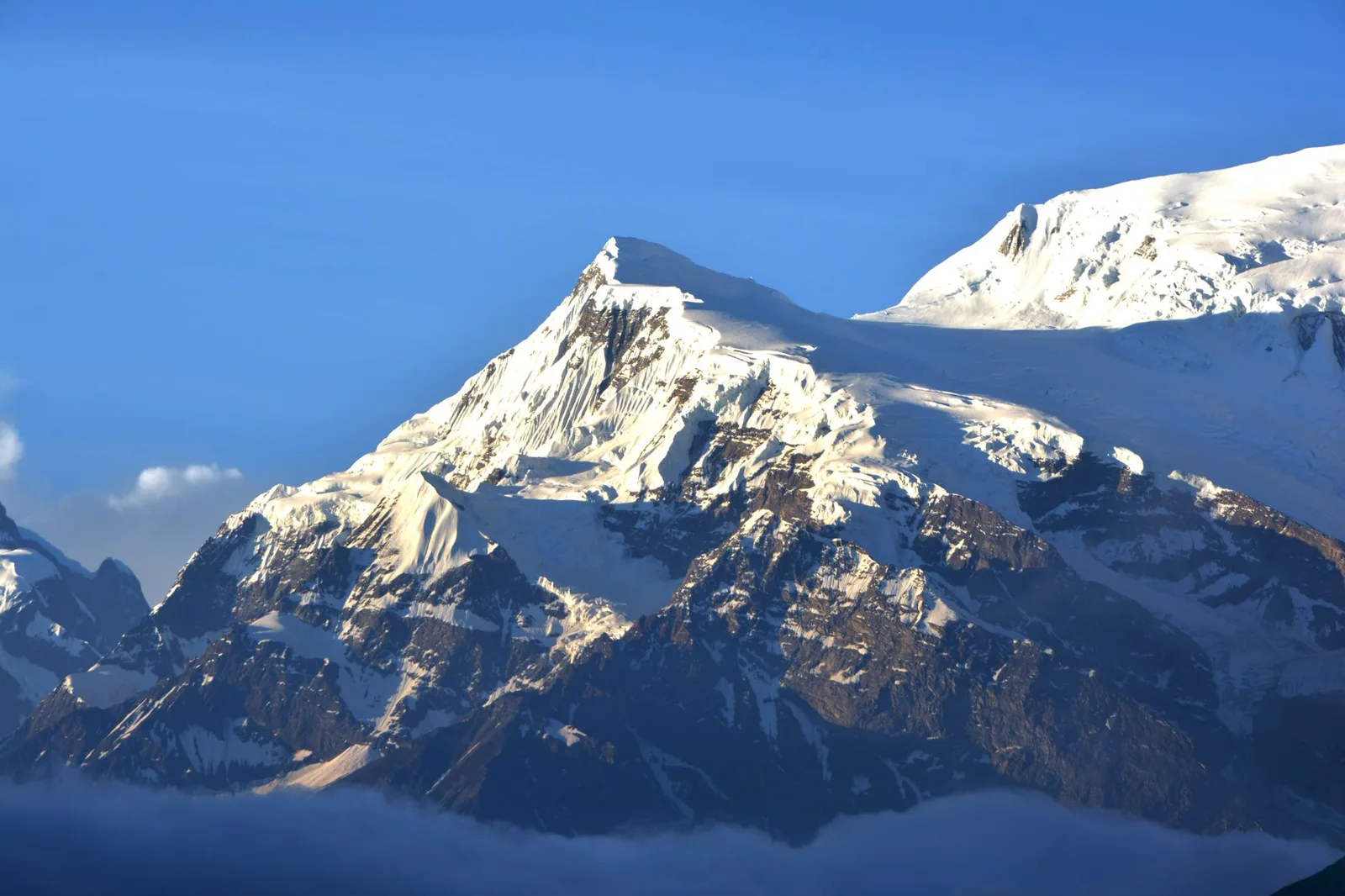 Bhutan Charges $100 a Night Before You've Even Booked a Bed. Nepal Charges Under $50 for the Whole Trek. The Honest 2026 Comparison