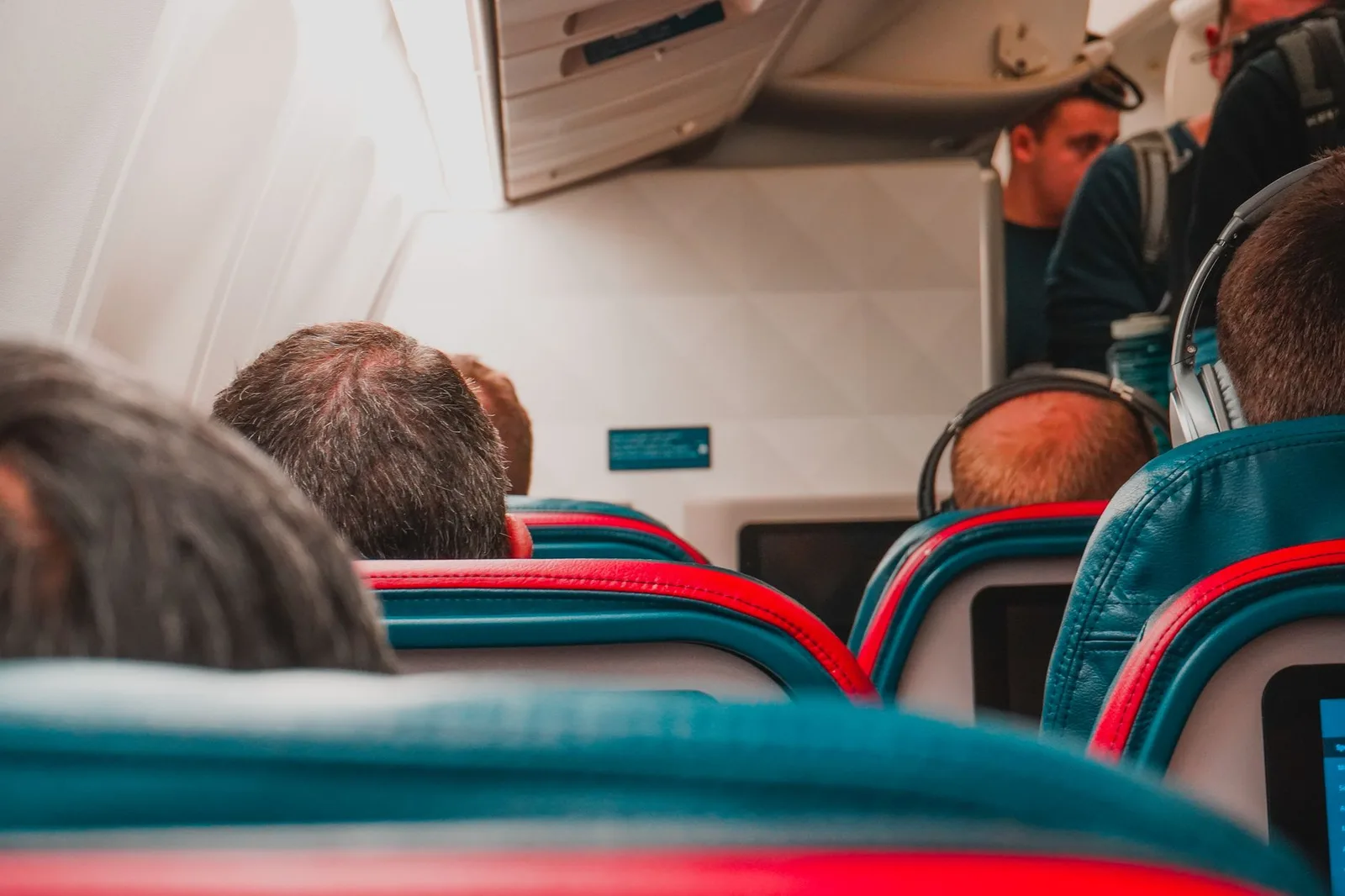 Wide, spacious premium-economy seats with extra legroom and footrests inside a passenger aircraft cabin