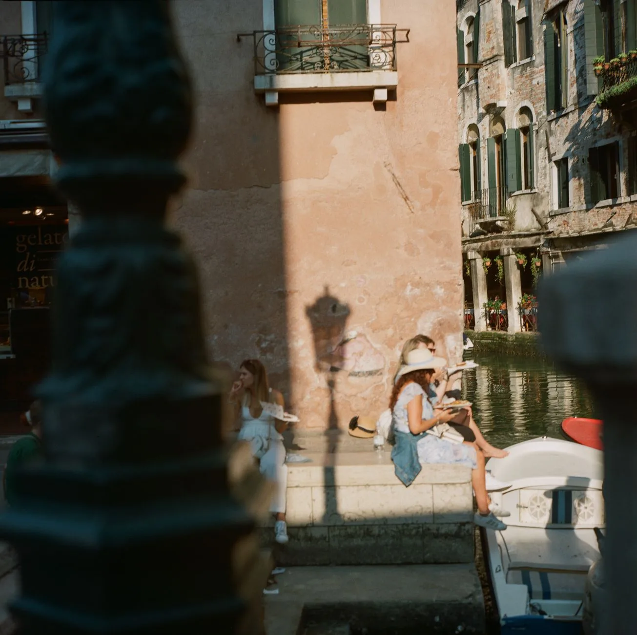 Tourists crossing a bridge over a canal in Venice, Italy, where a day-tripper access fee applies