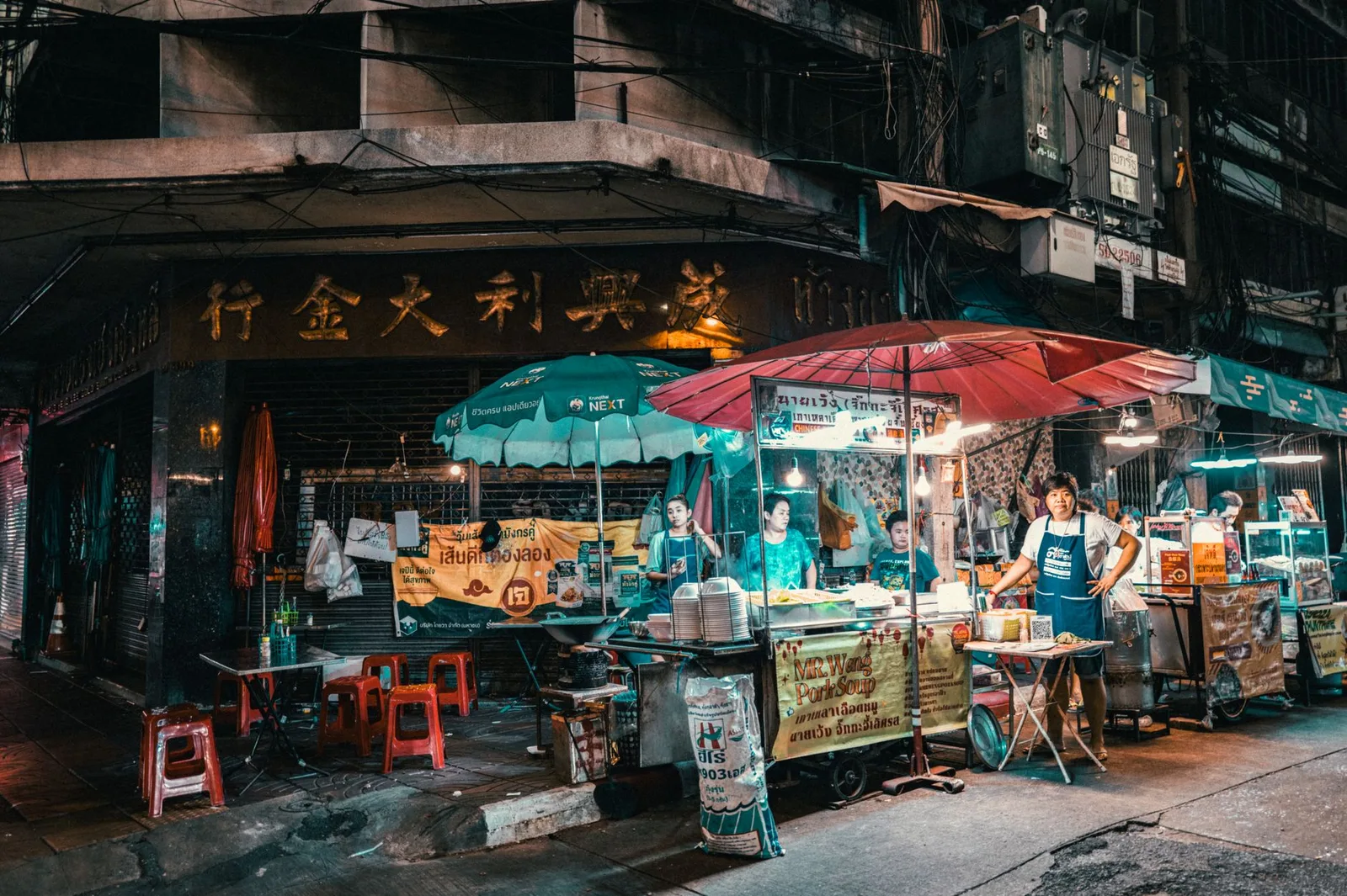 A busy street food market stall with cooked food and produce on display — where food and water hygiene decides whether travellers stay well or get sick