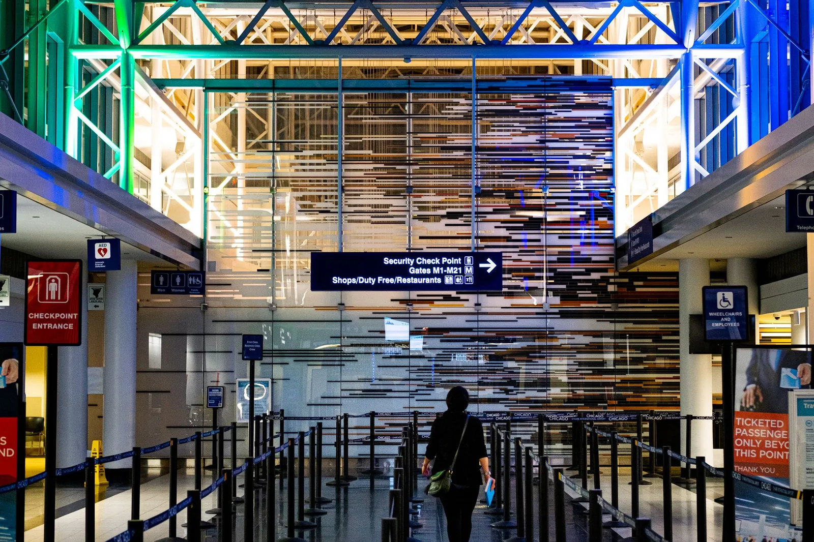Travellers waiting in line at an airport security screening checkpoint, the queue that trusted-traveller programs like TSA PreCheck are designed to shorten