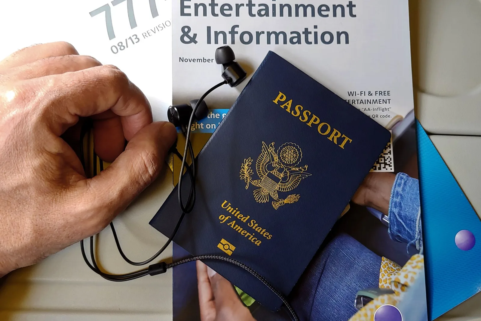A United States passport held at an airport — Visa Waiver Program travellers need an approved ESTA travel authorisation before flying to the US