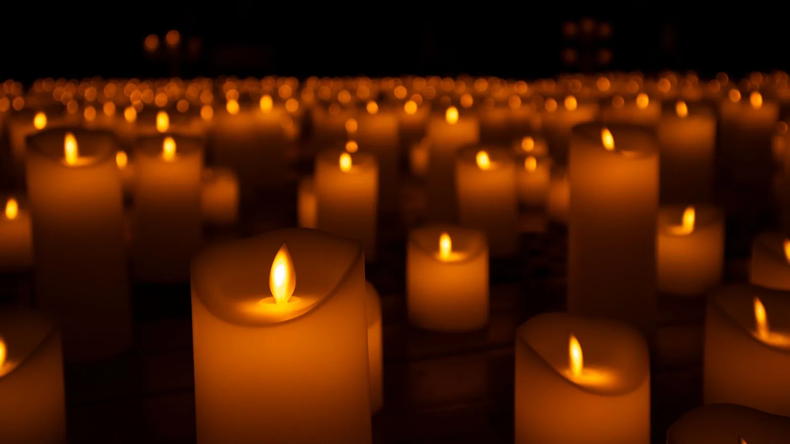 File photo: lit candles at a memorial vigil — an illustrative image of the condolences offered to Nepal by world and faith leaders after the 2026 floods; not from a specific ceremony