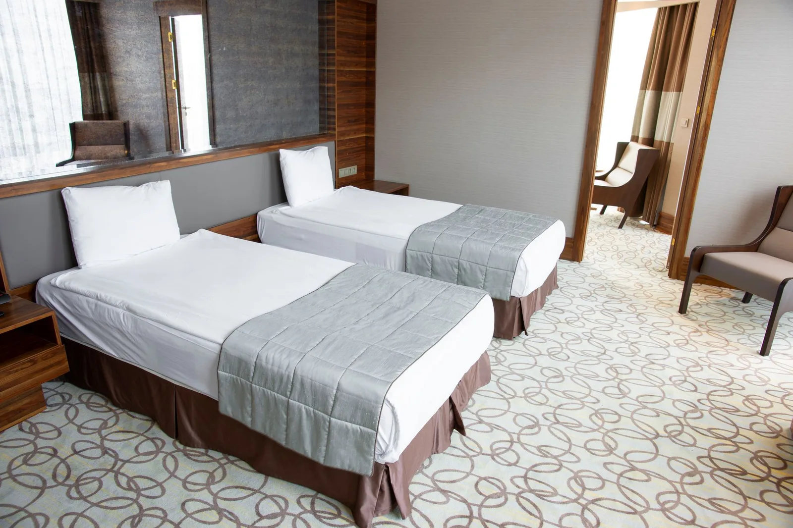 The interior of a lavish luxury hotel suite with a lounge and panoramic city view — illustrative of the world’s most expensive hotel accommodations