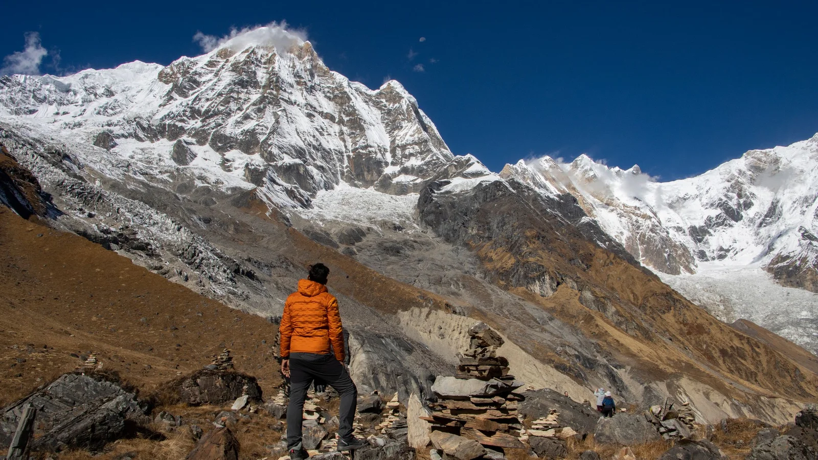 A trekker stands in awe of the majestic Annapurna mountain range in Nepal.