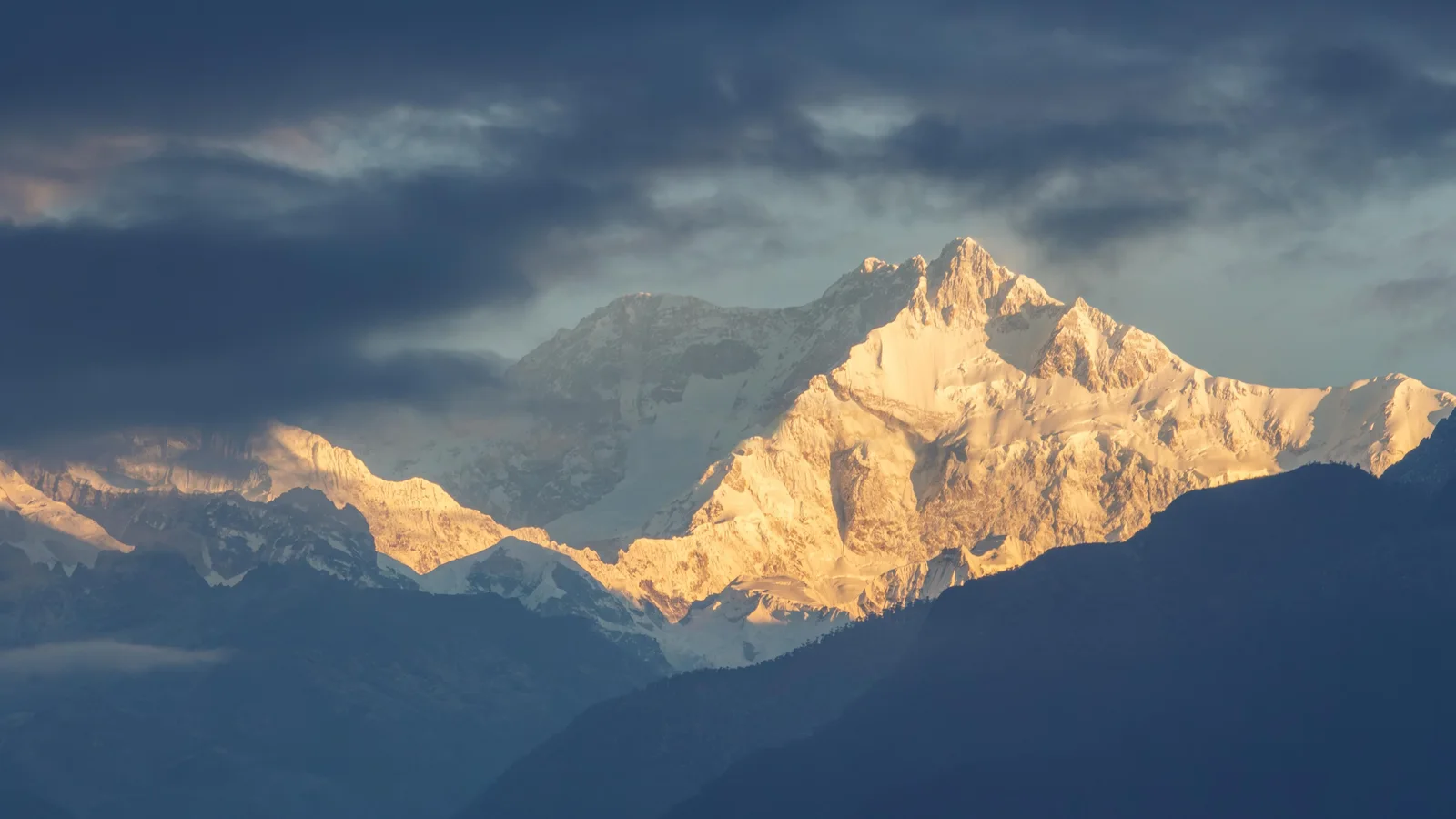 Spectacular sunrise lighting up Kanchenjunga peaks in Sikkim, India. Majestic winter landscape.