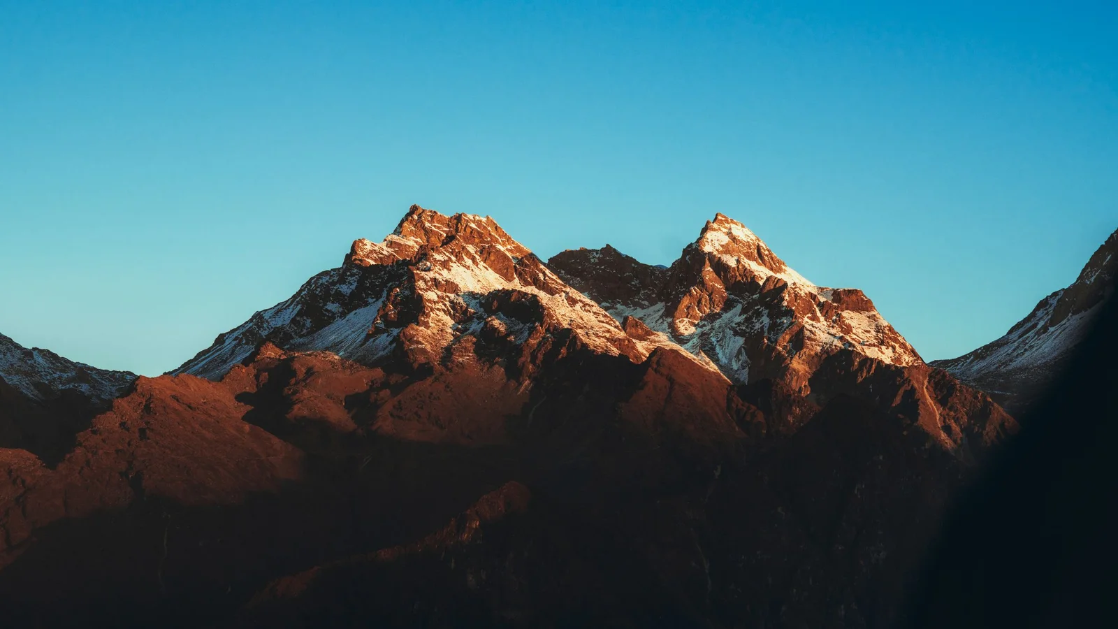 Stunning view of Himalayan mountain peaks in Nepal illuminated by warm sunrise light.