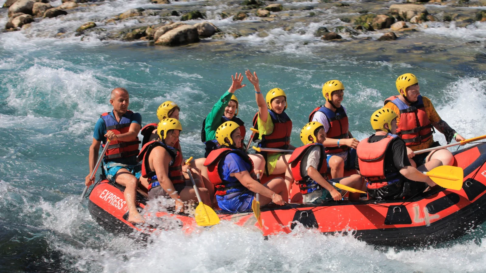 A group of adults enjoys an exciting whitewater rafting trip on a scenic river.